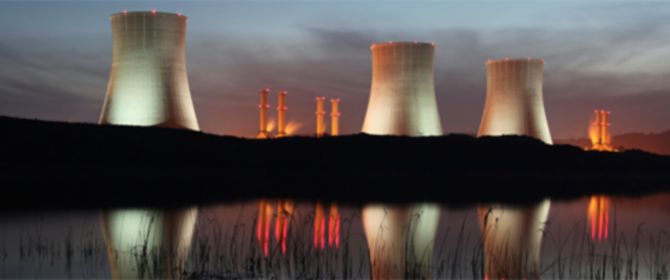 KPMG IFRS 15 (new revenue standard) for power and utilities image: A thermal power station next to a body of water. 
